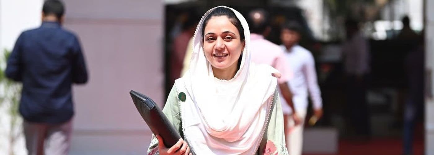 Sana Malik Shaikh smiling in a white headscarf at a public event